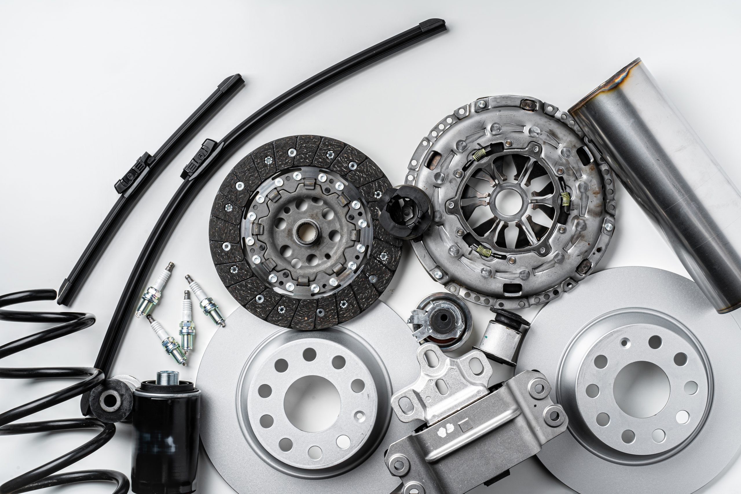 New metal auto parts on grey background